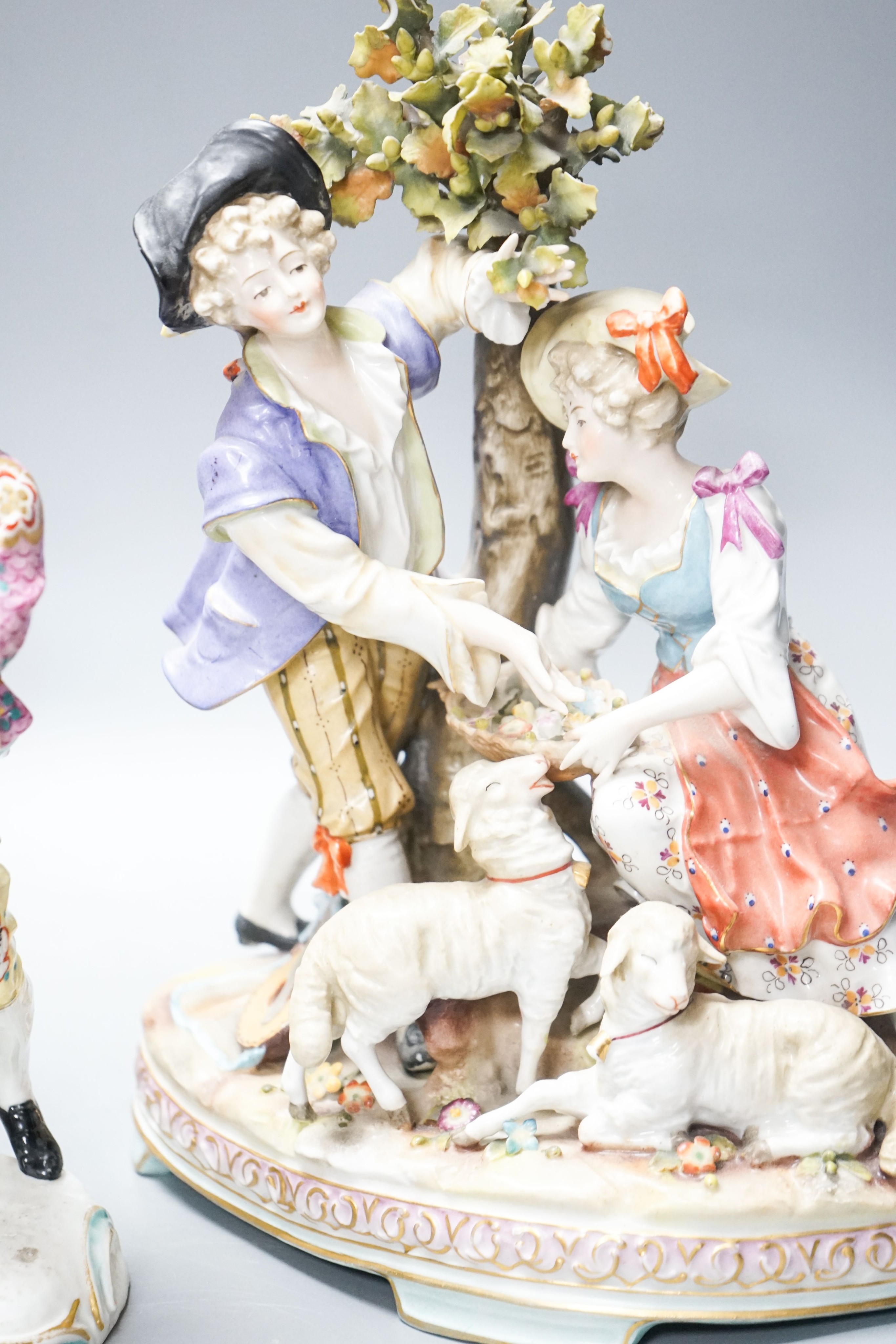 A Sitzendorf group of a Shepherd and shepherdess, three other Continental costume figures and a group (5) 27cm